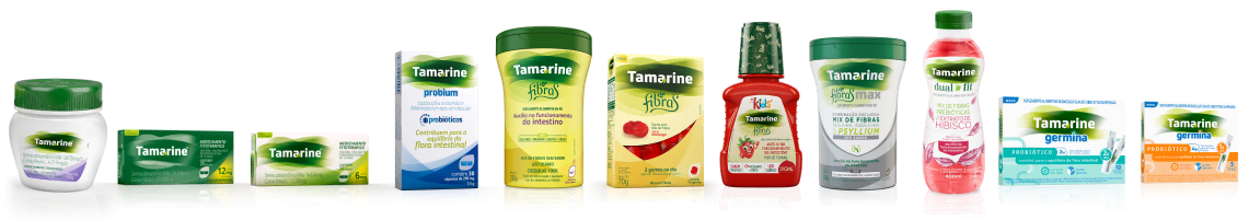 Imagem contendo todas as embalagens dos produtos de Tamarine, onde uma mão está pegando a embalagem  de Tamarine Probium bem no centro de todas.